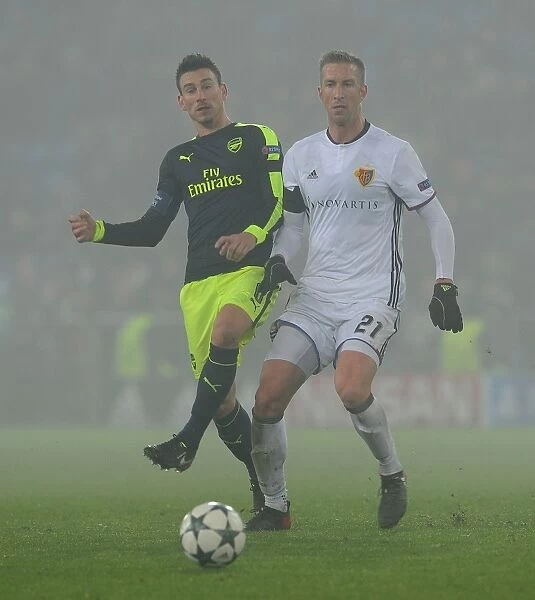 Arsenal's Laurent Koscielny Faces Off Against Marc Janko of FC Basel in 2016-17 UEFA Champions League