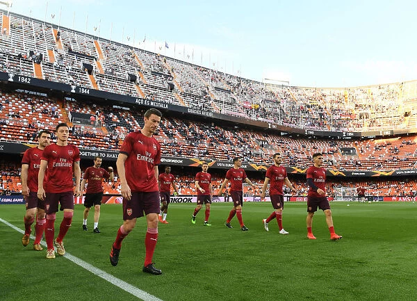 Arsenal's Laurent Koscielny Leads Pre-Match Warm-Up at Valencia's Estadio Mestalla (UEFA Europa League Semi-Final, Second Leg)
