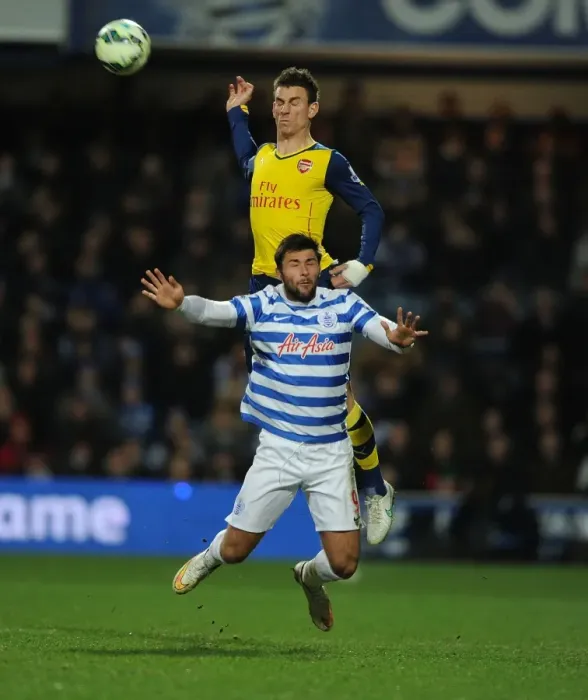 Framed Print : Arsenal's Laurent Koscielny Soars Above QPR's Charlie Austin in Premier League Clash