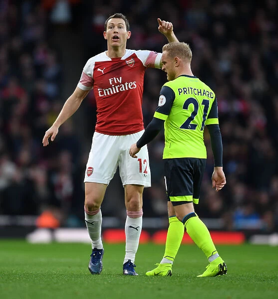 Arsenal's Lichtsteiner Marks Huddersfield's Pritchard in Premier League Clash