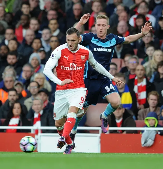 Framed Print : Arsenal's Lucas Perez Clashes with Middlesbrough's Adam Forshaw in Premier League Showdown