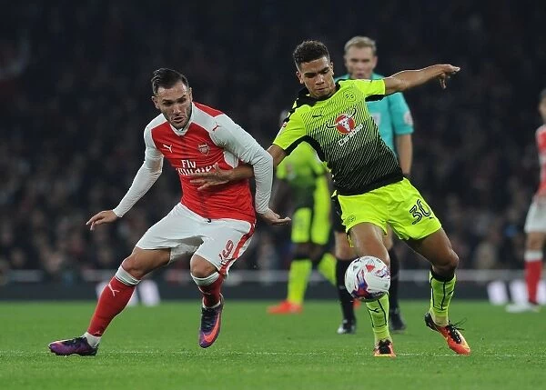 Arsenal's Lucas Perez Clashes with Reading's Tennai Watson in EFL Cup Showdown