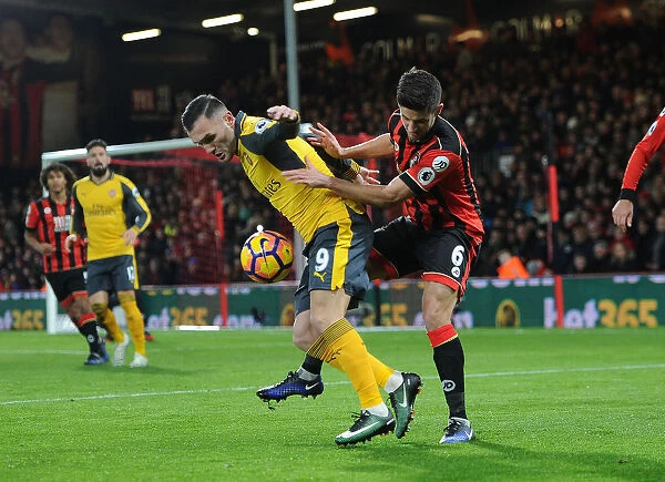 Arsenal's Lucas Perez Faces Pressure from Bournemouth's Andrew Surman in Premier League Clash
