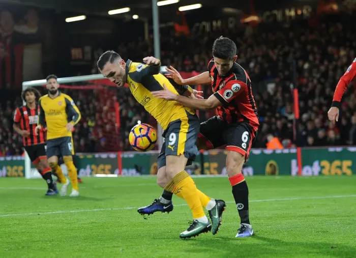 Framed Print : Arsenal's Lucas Perez Faces Pressure from Bournemouth's Andrew Surman in Premier League Clash Framed Print : Arsenal's Lucas Perez Faces Pressure from Bournemouth's Andrew Surman in Premier League Clash