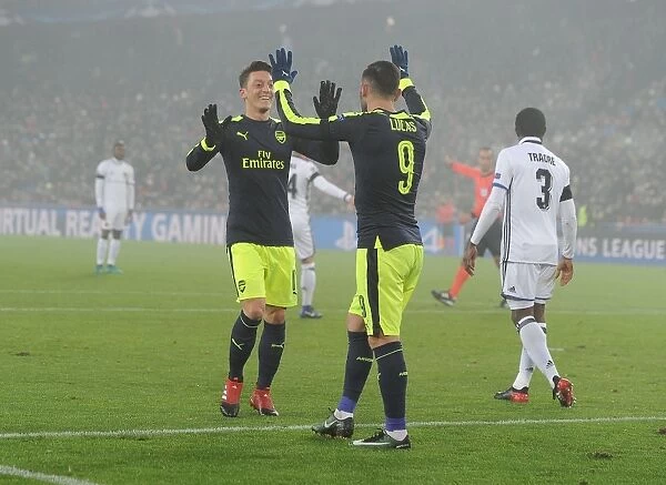 Arsenal's Lucas Perez and Mesut Ozil Celebrate Goals Against FC Basel in 2016-17 UEFA Champions League