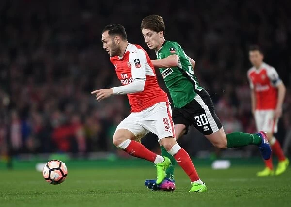 Arsenal's Lucas Perez Outmaneuvers Lincoln's Alex Woodyard in FA Cup Quarter-Final Showdown