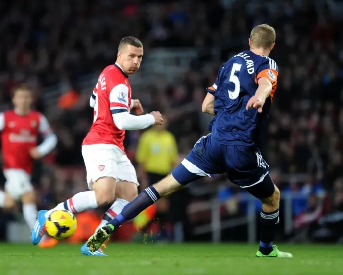 Framed Print : Arsenal's Lukas Podolski Clashes with Fulham's Brede Hangeland during the 2013-14 Premier League Match