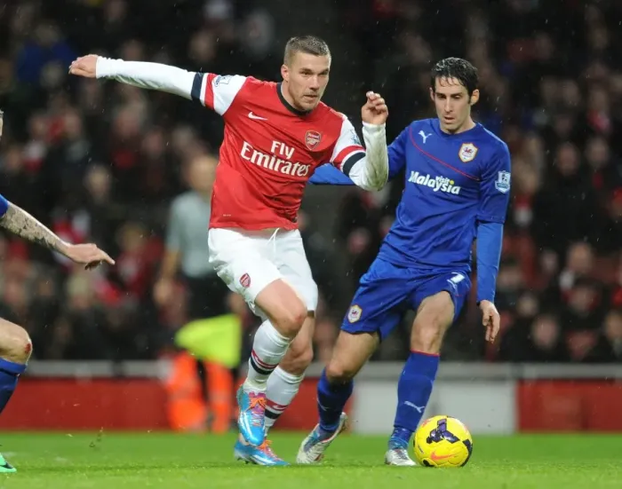 Framed Print : Arsenal's Lukas Podolski Faces Off Against Cardiff's Peter Whittingham in Premier League Clash Framed Print : Arsenal's Lukas Podolski Faces Off Against Cardiff's Peter Whittingham in Premier League Clash