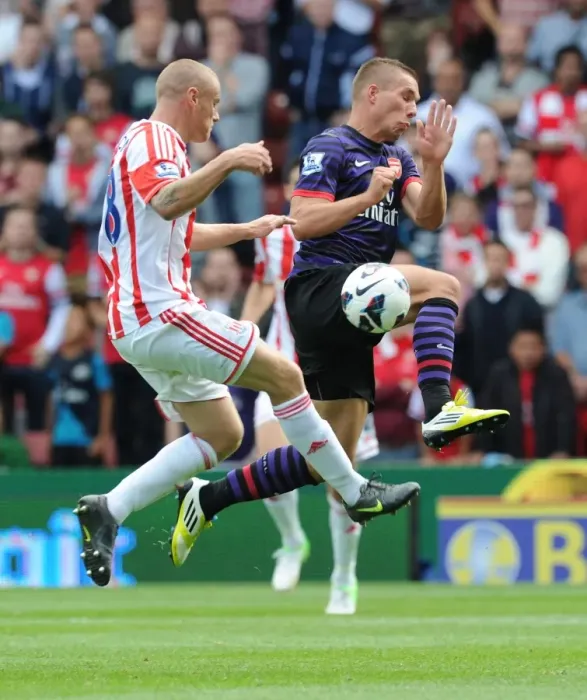 Framed Print : Arsenal's Lukas Podolski Faces Off Against Stoke City's Andy Wilkinson in 2012-13 Premier League Clash