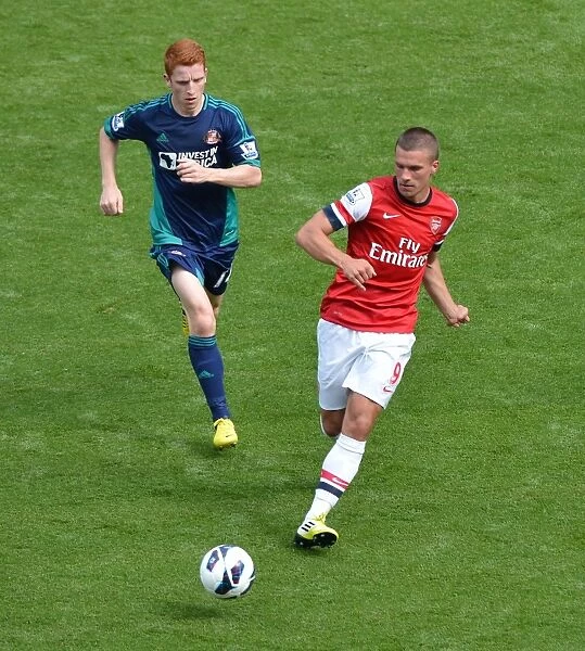 Arsenal's Lukas Podolski Faces Off Against Sunderland's Jack Colback at Emirates Stadium