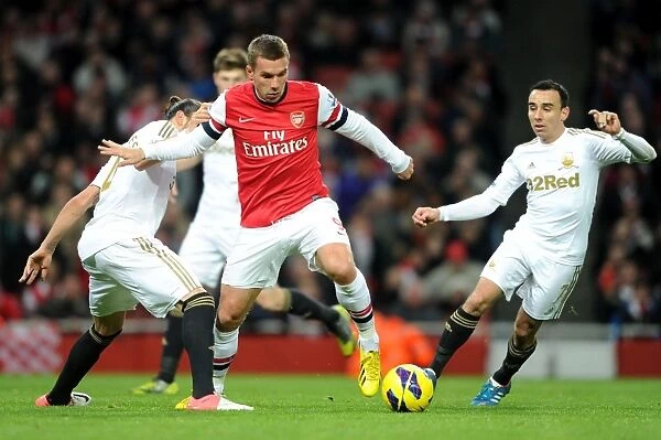 Arsenal's Lukas Podolski Fends Off Chico Flores and Leon Britton of Swansea during the 2012-13 Premier League Match