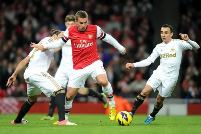 Framed Print : Arsenal's Lukas Podolski Fends Off Chico Flores and Leon Britton of Swansea during the 2012-13 Premier League Match
