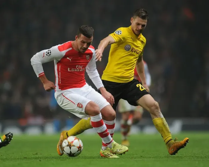 Framed Print : Arsenal's Lukas Podolski Outmaneuvers Borussia Dortmund's Lukasz Piszczek in 2014-15 Champions League Clash Framed Print : Arsenal's Lukas Podolski Outmaneuvers Borussia Dortmund's Lukasz Piszczek in 2014-15 Champions League Clash