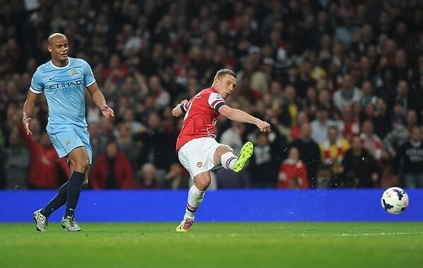 Arsenal's Lukas Podolski Outmaneuvers Manchester City's Vincent Kompany in the 2013 / 14 Premier League Clash