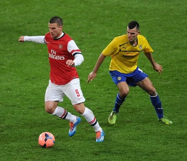 Arsenal's Lukas Podolski Outruns Coventry's Conor Thomas in FA Cup Fourth Round Clash