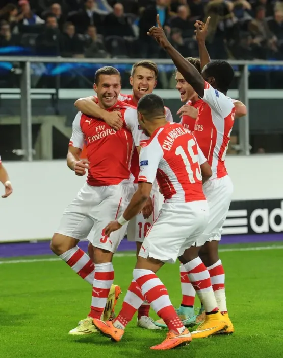 Framed Print : Arsenal's Lukas Podolski Scores and Celebrates with Teammates against RSC Anderlecht in UEFA Champions League, 2014