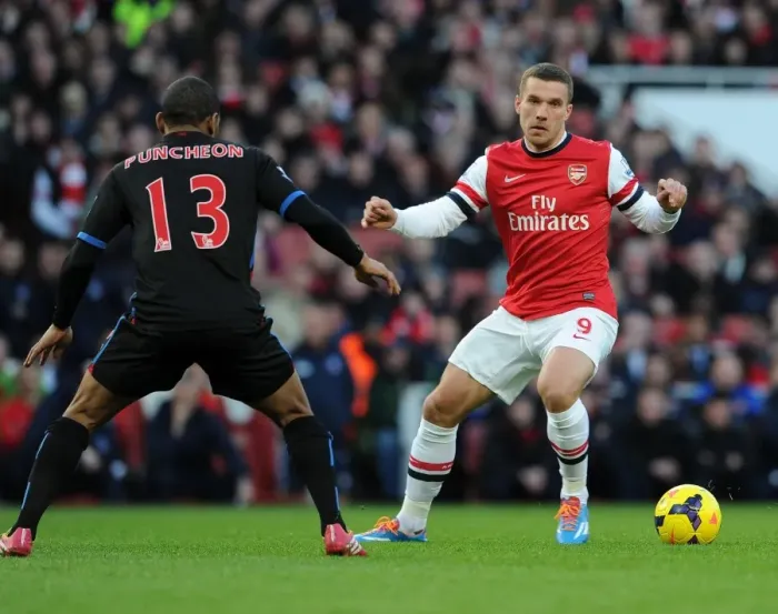 Framed Print : Arsenal's Lukas Podolski Tangles with Crystal Palace's Jason Puncheon in Premier League Clash
