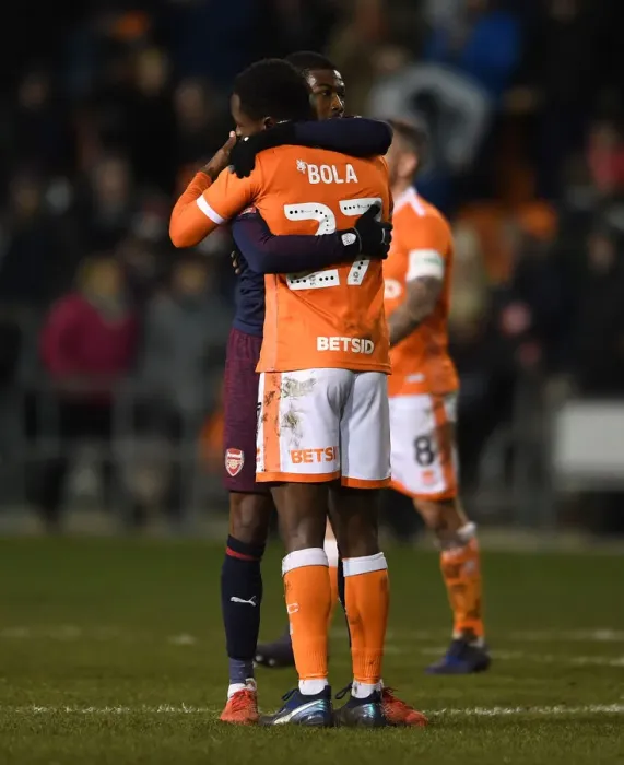 Framed Print : Arsenal's Maitland-Niles Embraces Blackpool's Bola After FA Cup Third Round Match