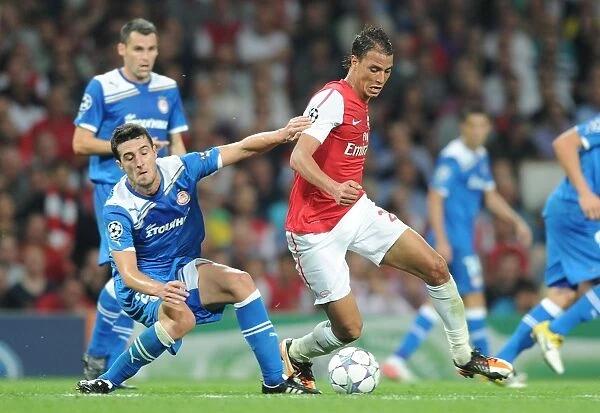 Arsenal's Marouane Chamakh Clashes with Olympiacos Ivan Marcano in 2011 Champions League Showdown