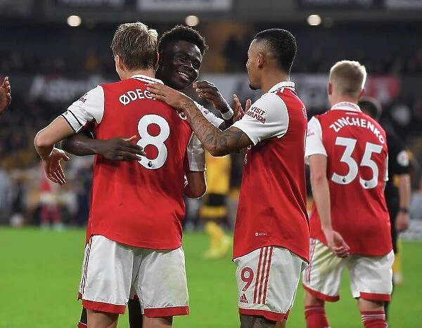 Arsenal's Martin Odegaard and Bukayo Saka Celebrate Goals Against Wolverhampton Wanderers in Premier League Match, 2022-23