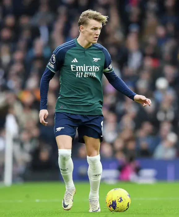 Framed Print : Arsenal's Martin Odegaard Charges Forward in Premier League Clash Against Fulham (2023-24)