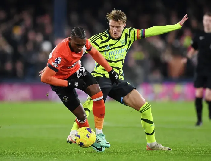 Framed Print : Arsenal's Martin Odegaard Faces Off Against Luton Town's Amari Bell in Premier League Clash (Luton Town vs Arsenal 2023-24)
