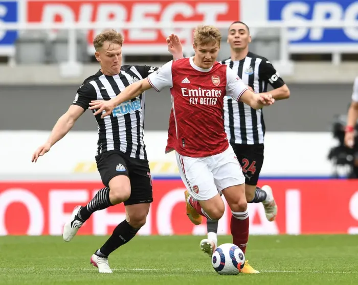 Framed Print : Arsenal's Martin Odegaard Faces Off Against Newcastle's Matt Ritchie in Empty St. James Park - Premier League Clash 2021