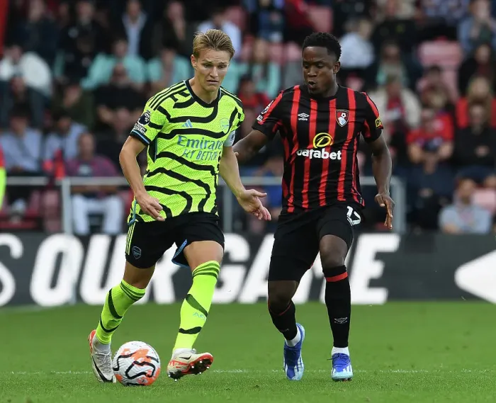 Framed Print : Arsenal's Martin Odegaard Faces Pressure from Bournemouth's Luis Sinisterra in Premier League Clash (AFC Bournemouth vs Arsenal 2023-24)