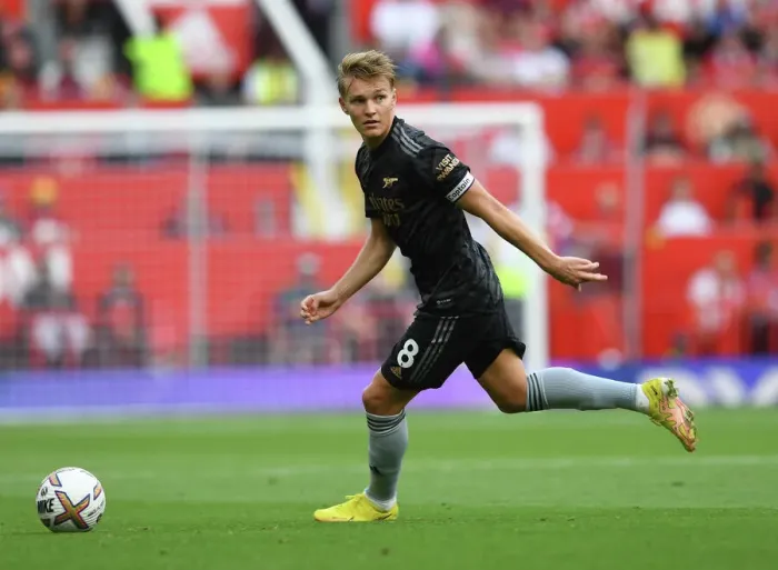 Framed Print : Arsenal's Martin Odegaard Goes Head-to-Head with Manchester United in Premier League Clash (2022-23)