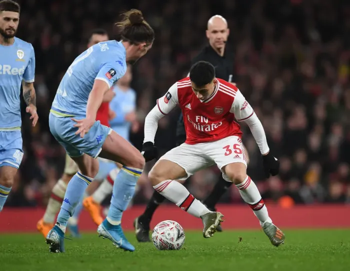 Framed Print : Arsenal's Martinelli Clashes with Leeds Ayling in FA Cup Showdown