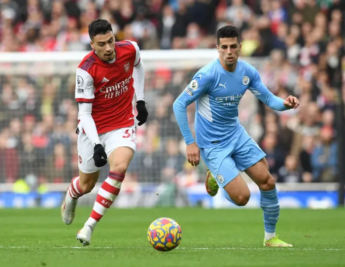 Framed Print : Arsenal's Martinelli Clashes with Manchester City's Cancelo in Premier League Showdown Framed Print : Arsenal's Martinelli Clashes with Manchester City's Cancelo in Premier League Showdown