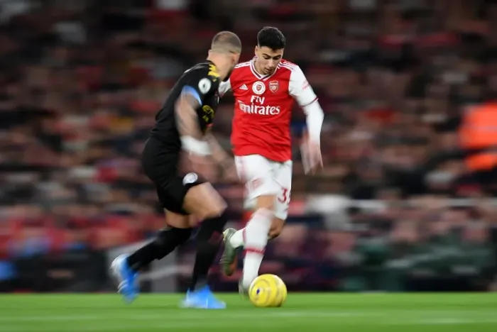 Framed Print : Arsenal's Martinelli Clashes with Manchester City's Walker in Premier League Showdown