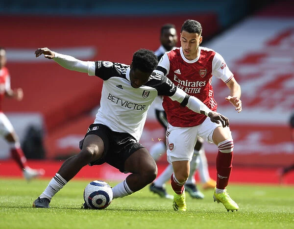 Arsenal's Martinelli Faces Off Against Fulham's Aina in Empty Emirates Stadium
