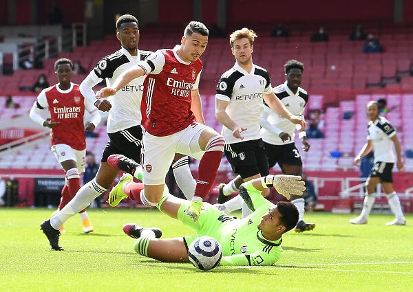 Arsenal's Martinelli Faces Off Against Fulham's Areola in Empty Emirates Stadium
