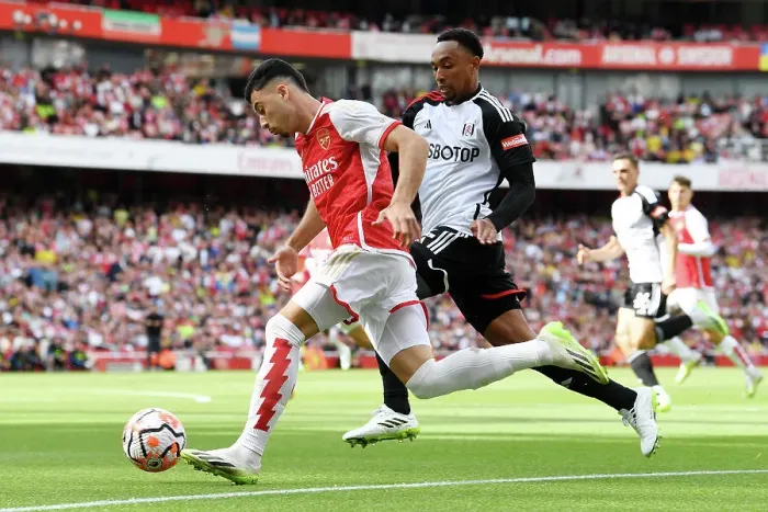 Framed Print : Arsenal's Martinelli Fends Off Fulham's Tete in Premier League Clash (2023-24) Framed Print : Arsenal's Martinelli Fends Off Fulham's Tete in Premier League Clash (2023-24)