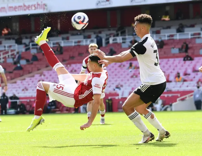 Framed Print : Arsenal's Martinelli Goes for Bicycle Kick Against Fulham in Empty Emirates Stadium