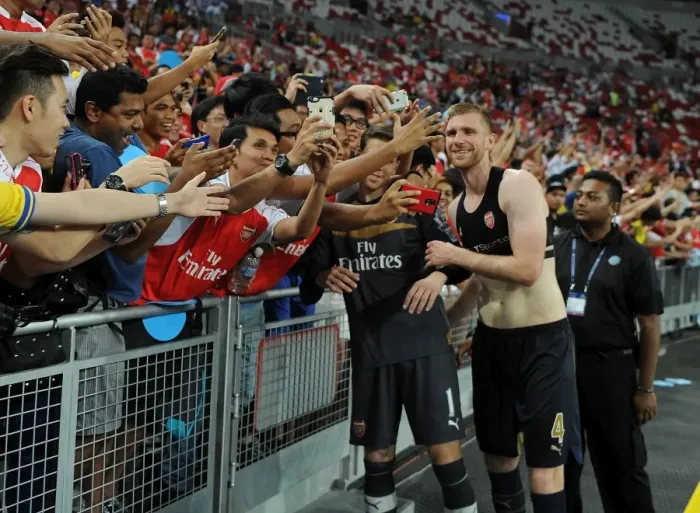 Framed Print : Arsenal's Per Mertesacker Celebrates with Fans after Arsenal's Victory over Singapore XI in Singapore, 2015 Framed Print : Arsenal's Per Mertesacker Celebrates with Fans after Arsenal's Victory over Singapore XI in Singapore, 2015