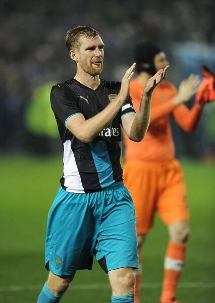 Arsenal's Per Mertesacker Celebrates with Fans after Capital One Cup Victory over Sheffield Wednesday