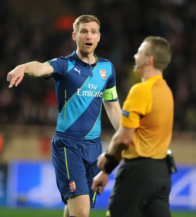 Framed Print : Arsenal's Per Mertesacker Confers with Referee during Monaco Showdown in 2015 Champions League