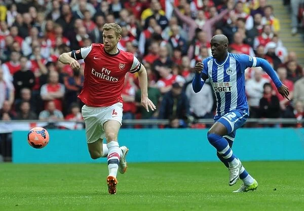 Arsenal's Per Mertesacker Faces Off Against Wigan's Marc-Antoine Fortune in FA Cup Semi-Final Showdown
