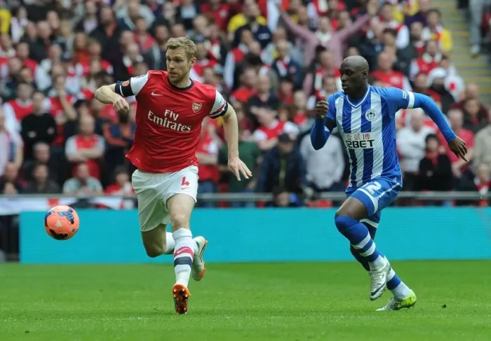 Framed Print : Arsenal's Per Mertesacker Faces Off Against Wigan's Marc-Antoine Fortune in FA Cup Semi-Final Showdown
