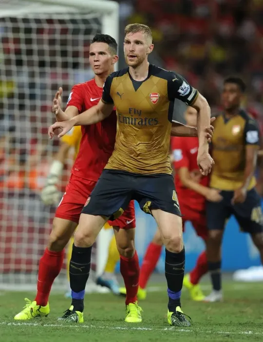 Framed Print : Arsenal's Per Mertesacker Fends Off Opponent in Barclays Asia Trophy Clash vs Singapore (July 15, 2015)