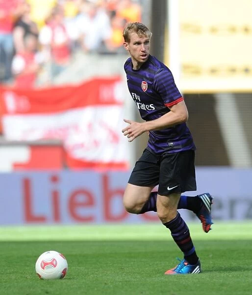 Arsenal's Per Mertesacker Goes Head-to-Head with FC Cologne in 2012 Pre-Season Clash