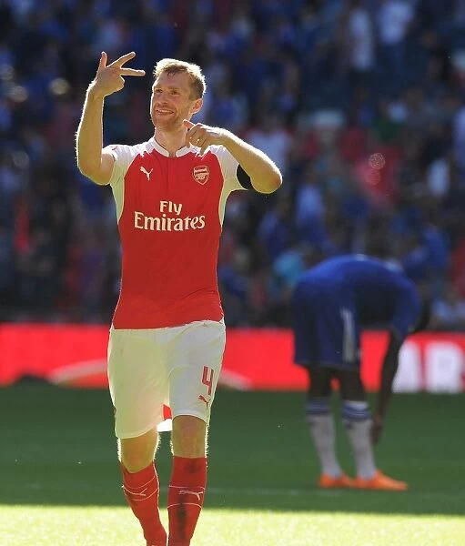 Arsenal's Per Mertesacker Leads the Celebration: Community Shield Victory over Chelsea