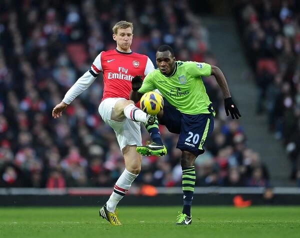 Arsenal's Per Mertesacker Wins Ball from Aston Villa's Christian Benteke in Premier League Clash