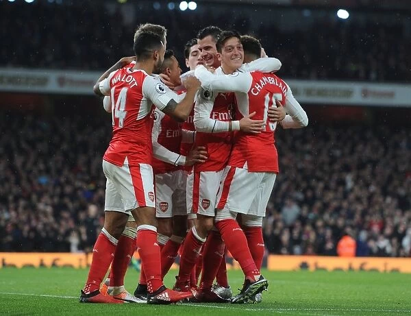 Arsenal's Mesut Ozil, Alex Oxlade-Chamberlain, and Theo Walcott Celebrate Goals Against Stoke City (2016-17)
