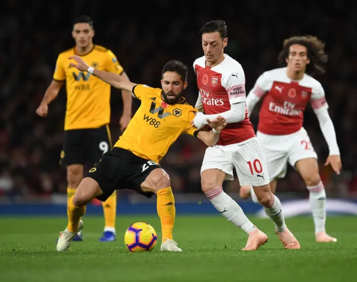 Framed Print : Arsenal's Mesut Özil Clashes with João Moutinho in Premier League Showdown (Arsenal v Wolverhampton Wanderers, 2018-19)