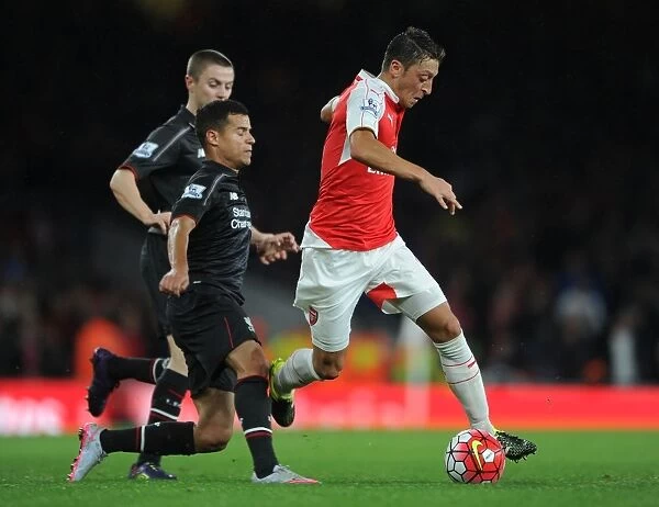 Arsenal's Mesut Ozil Clashes with Liverpool's Coutinho and Rossiter in Intense Arsenal vs Liverpool Premier League Showdown (2015 / 16)