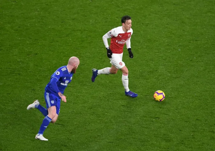 Framed Print : Arsenal's Mesut Ozil Faces Off Against Cardiff's Aron Gunnarsson in Premier League Clash Framed Print : Arsenal's Mesut Ozil Faces Off Against Cardiff's Aron Gunnarsson in Premier League Clash