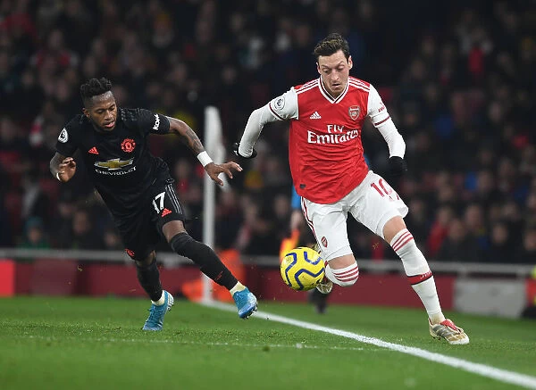 Arsenal's Mesut Ozil Outmaneuvers Manchester United's Fred in Premier League Clash